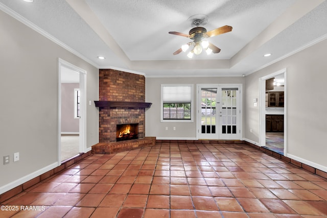 504 Presbytere Pkwy, Lafayette, LA 70503 - unfurnished living room with a raised ceiling, a textured ceiling, ceiling fan, tile patterned floors, and baseboards