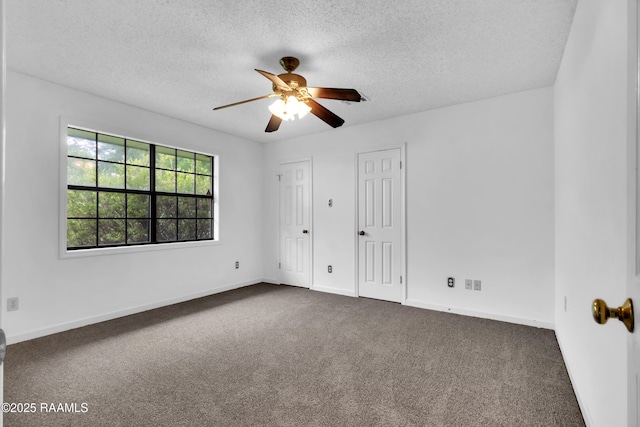 504 Presbytere Pkwy, Lafayette, LA 70503 - unfurnished bedroom with a textured ceiling, dark colored carpet, two closets, baseboards, and ceiling fan