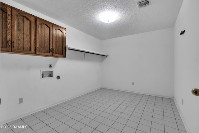 504 Presbytere Pkwy, Lafayette, LA 70503 - laundry room featuring hookup for an electric dryer, a textured ceiling, cabinet space, hookup for a washing machine, and baseboards