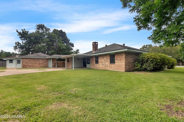504 Presbytere Pkwy, Lafayette, LA 70503 - view of front of home featuring brick siding, a chimney, a front yard, and driveway