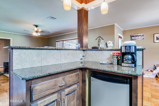 102 White Cir, Lafayette, LA 70506 - kitchen featuring refrigerator, a ceiling fan, stone countertops, and crown molding