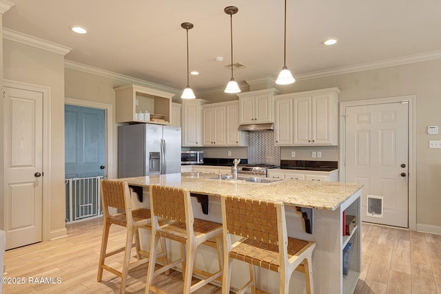 209 E Vincent St, Maurice, LA 70555 - kitchen featuring open shelves, light wood-style floors, a sink, appliances with stainless steel finishes, and under cabinet range hood