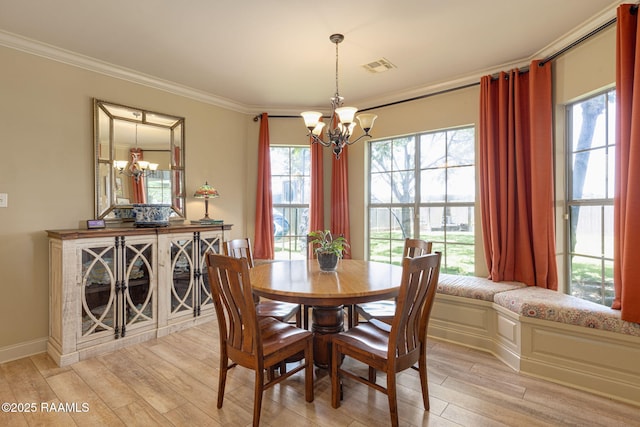 209 E Vincent St, Maurice, LA 70555 - dining space with a chandelier, crown molding, light wood-style floors, and baseboards
