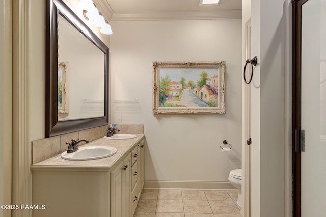 209 E Vincent St, Maurice, LA 70555 - bathroom with double vanity, toilet, ornamental molding, tile patterned flooring, and baseboards