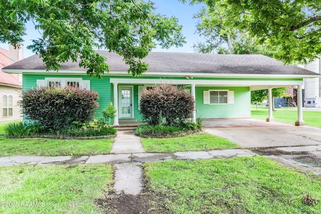 405 E Louisiana Ave, Rayne, LA 70578 - view of front of house with a carport, concrete driveway, a front yard, and a shingled roof