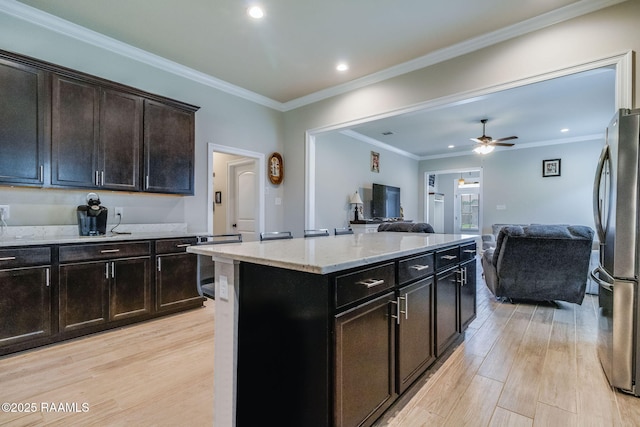 111 Rose Of Sharon Ln, Lafayette, LA 70508 - kitchen with freestanding refrigerator, light wood-style flooring, open floor plan, light stone counters, and recessed lighting