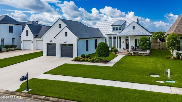 207 Bronze Palm Way, Youngsville, LA 70592 - modern inspired farmhouse with a standing seam roof, concrete driveway, a porch, a metal roof, and a garage
