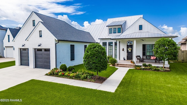 207 Bronze Palm Way, Youngsville, LA 70592 - modern farmhouse style home with driveway, a standing seam roof, a porch, ceiling fan, and brick siding