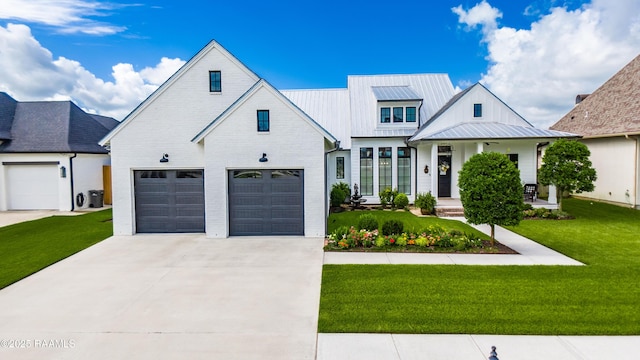 207 Bronze Palm Way, Youngsville, LA 70592 - modern inspired farmhouse featuring concrete driveway, an attached garage, a front yard, and a standing seam roof