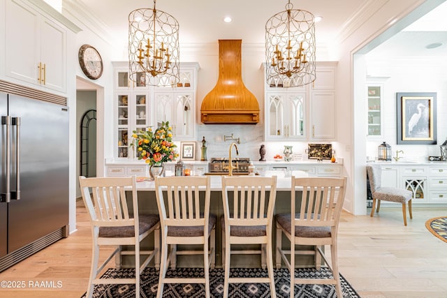 207 Bronze Palm Way, Youngsville, LA 70592 - kitchen featuring built in fridge, a chandelier, custom range hood, crown molding, and light countertops