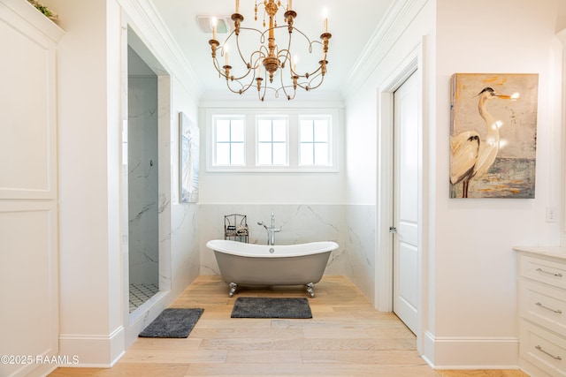 207 Bronze Palm Way, Youngsville, LA 70592 - full bathroom with ornamental molding, a soaking tub, a chandelier, wood finished floors, and vanity