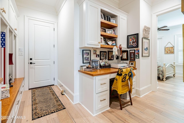 207 Bronze Palm Way, Youngsville, LA 70592 - home office featuring built in study area, crown molding, light wood finished floors, and ceiling fan