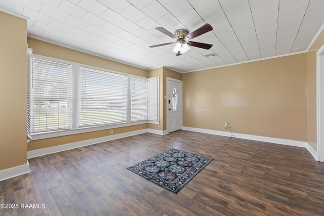 206 N Fernand St, Delcambre, LA 70528 - entrance foyer with a ceiling fan, dark wood finished floors, ornamental molding, and baseboards