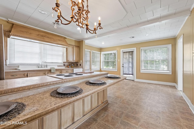 206 N Fernand St, Delcambre, LA 70528 - kitchen with light brown cabinetry, a chandelier, and light countertops