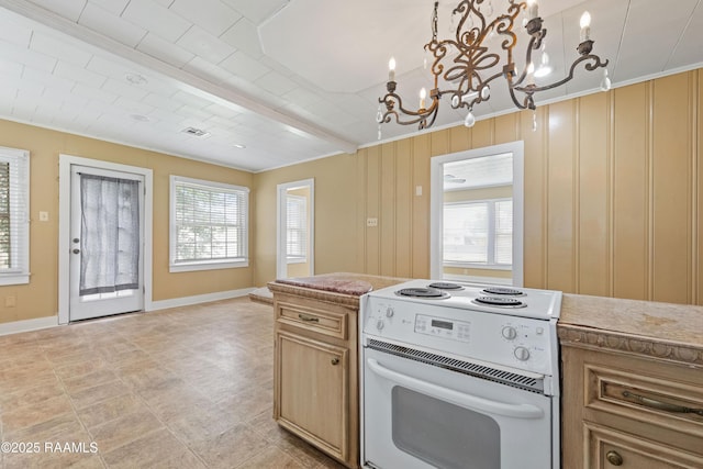 206 N Fernand St, Delcambre, LA 70528 - kitchen featuring white electric range oven, healthy amount of natural light, a chandelier, baseboards, and crown molding