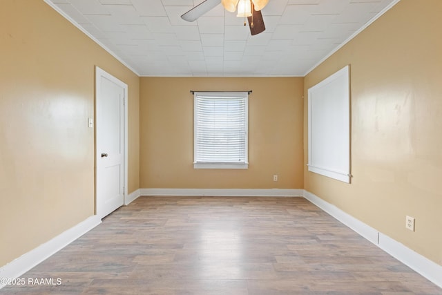 206 N Fernand St, Delcambre, LA 70528 - empty room with ornamental molding, ceiling fan, wood finished floors, and baseboards