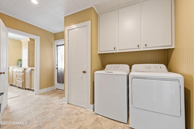 206 N Fernand St, Delcambre, LA 70528 - laundry room featuring washer and clothes dryer, cabinet space, and wooden walls