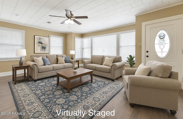 206 N Fernand St, Delcambre, LA 70528 - living room featuring ornamental molding, a ceiling fan, plenty of natural light, and wood finished floors
