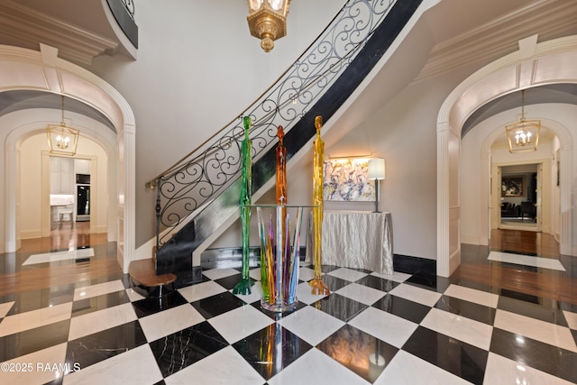 12425 N Marcus Rd, Abbeville, LA 70510 - tiled entryway with arched walkways, stairs, ornamental molding, and baseboards