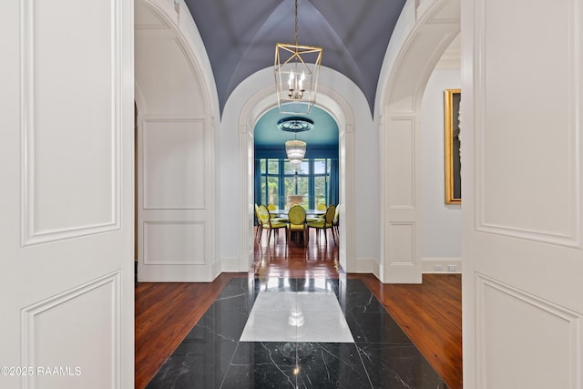 12425 N Marcus Rd, Abbeville, LA 70510 - entrance foyer with arched walkways, a chandelier, and marble tiled floors