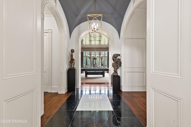 12425 N Marcus Rd, Abbeville, LA 70510 - hall featuring a chandelier, arched walkways, and vaulted ceiling