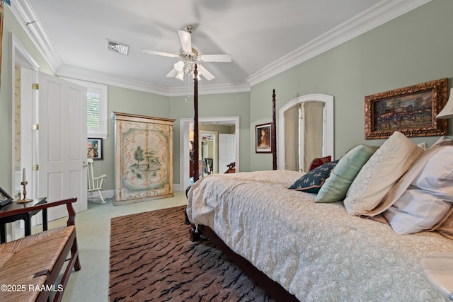 12425 N Marcus Rd, Abbeville, LA 70510 - carpeted bedroom featuring ornamental molding, ceiling fan, baseboards, and arched walkways