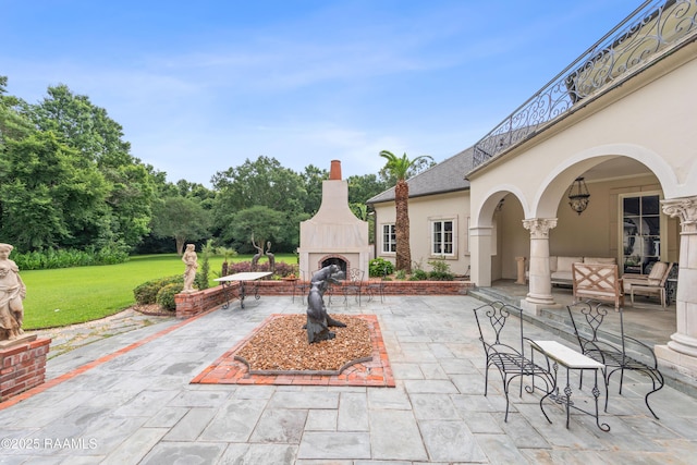 12425 N Marcus Rd, Abbeville, LA 70510 - view of patio / terrace with an outdoor living space with a fireplace