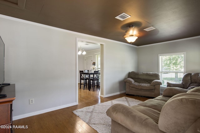 1037 Joe Kidder Rd, Arnaudville, LA 70512 - living room with wood finished floors, baseboards, crown molding, and a chandelier
