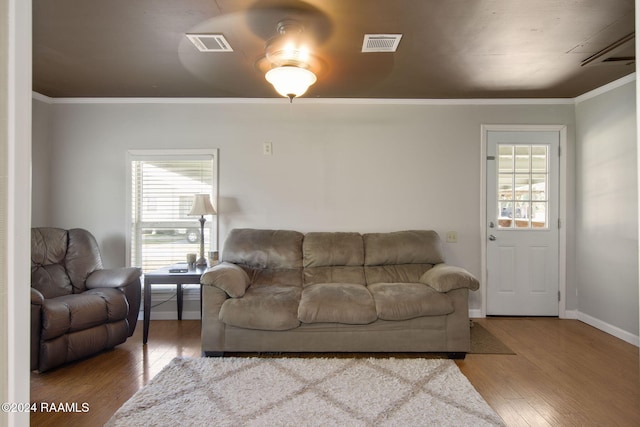 1037 Joe Kidder Rd, Arnaudville, LA 70512 - living area with wood finished floors, plenty of natural light, crown molding, and baseboards
