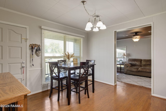1037 Joe Kidder Rd, Arnaudville, LA 70512 - dining area featuring crown molding, a chandelier, wood finished floors, and baseboards