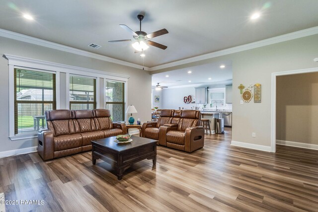 604 Bay Meadow Ln, Lafayette, LA 70507 - living room featuring ceiling fan, wood finished floors, plenty of natural light, recessed lighting, and crown molding