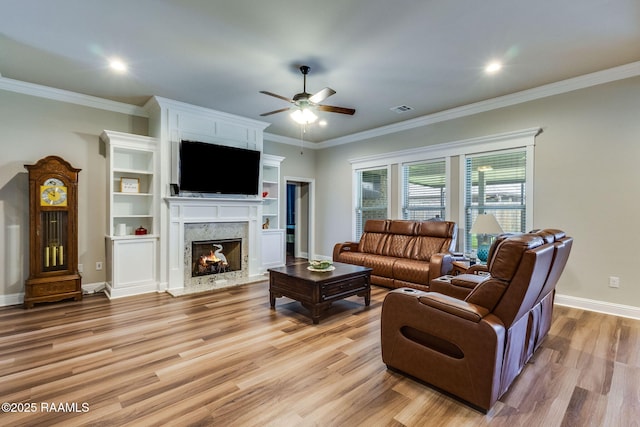 604 Bay Meadow Ln, Lafayette, LA 70507 - living area with a ceiling fan, light wood finished floors, baseboards, a high end fireplace, and crown molding