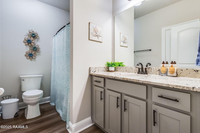 604 Bay Meadow Ln, Lafayette, LA 70507 - full bathroom featuring vanity, toilet, wood finished floors, and baseboards