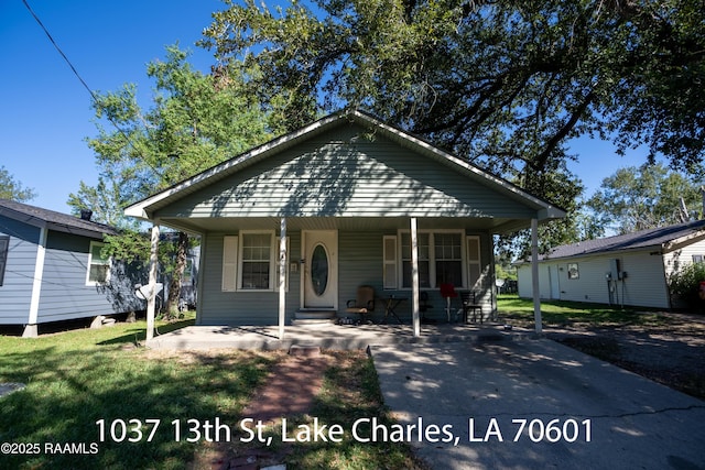 718 14th St, Lake Charles, LA 70601 - bungalow with covered porch and a front lawn