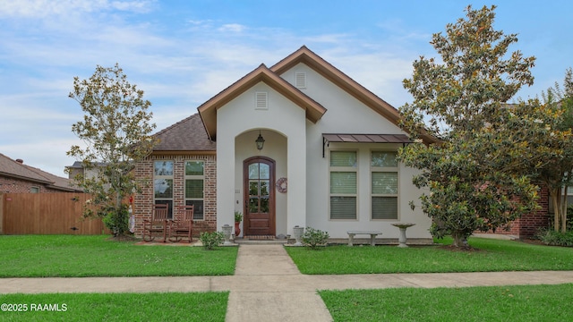 111 Grand Pointe Blvd, Lafayette, LA 70508 - view of front of house featuring stucco siding, brick siding, and a standing seam roof