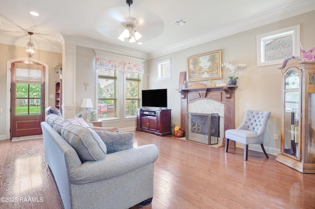 111 Grand Pointe Blvd, Lafayette, LA 70508 - living area featuring arched walkways, a fireplace with flush hearth, plenty of natural light, ornamental molding, and wood finished floors