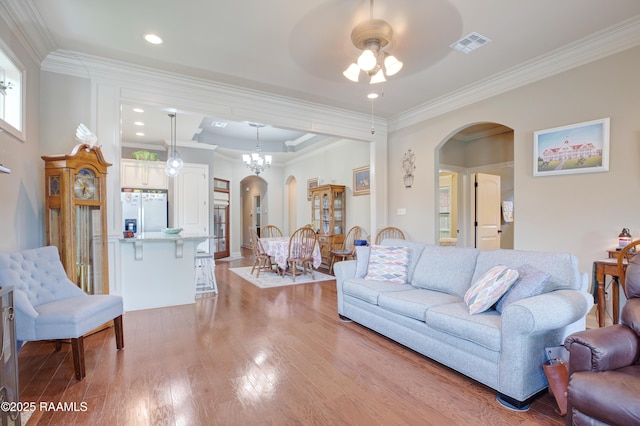 111 Grand Pointe Blvd, Lafayette, LA 70508 - living area with arched walkways, a ceiling fan, light wood-style flooring, crown molding, and recessed lighting