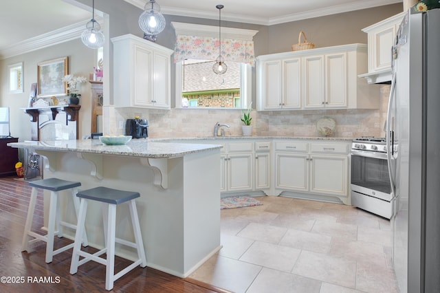 111 Grand Pointe Blvd, Lafayette, LA 70508 - kitchen featuring appliances with stainless steel finishes, tasteful backsplash, white cabinetry, light stone countertops, and ornamental molding