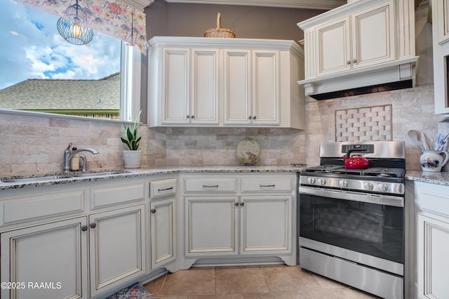 111 Grand Pointe Blvd, Lafayette, LA 70508 - kitchen with stainless steel range with gas stovetop, a sink, tasteful backsplash, light stone counters, and light tile patterned floors