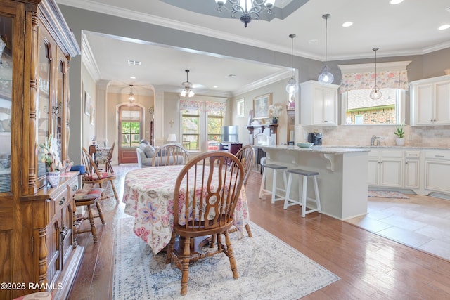 111 Grand Pointe Blvd, Lafayette, LA 70508 - dining space with light wood-style floors, recessed lighting, crown molding, and a chandelier