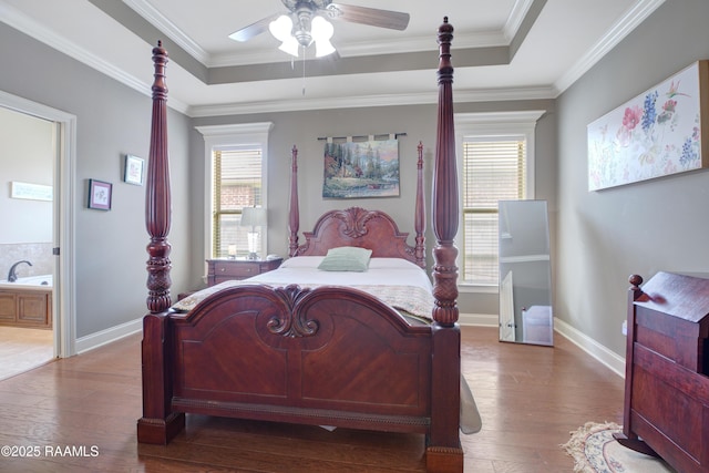 111 Grand Pointe Blvd, Lafayette, LA 70508 - bedroom featuring hardwood / wood-style floors, multiple windows, a tray ceiling, baseboards, and ornamental molding
