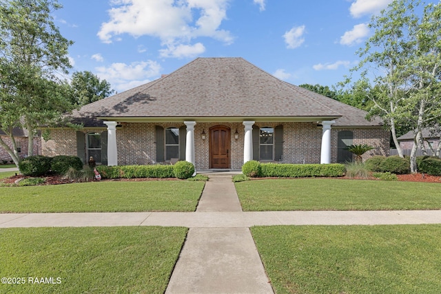 106 Arapahoe Dr, Lafayette, LA 70503 - view of front facade featuring brick siding, a front yard, and a shingled roof