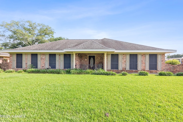 510 Monarch Dr, Lafayette, LA 70506 - view of front facade featuring a front lawn, brick siding, and roof with shingles