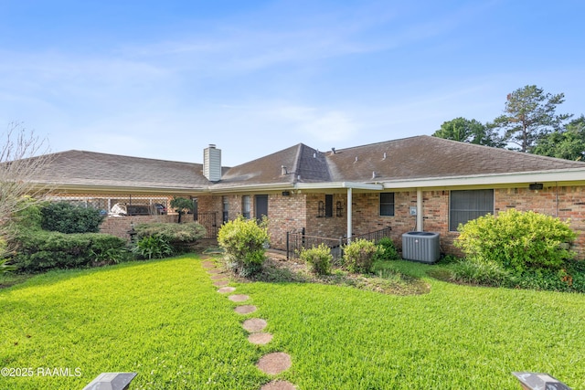 510 Monarch Dr, Lafayette, LA 70506 - back of house featuring a yard, a chimney, and brick siding