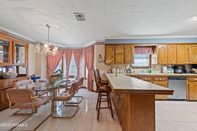 510 Monarch Dr, Lafayette, LA 70506 - kitchen with dishwasher, a peninsula, crown molding, a chandelier, and a kitchen bar