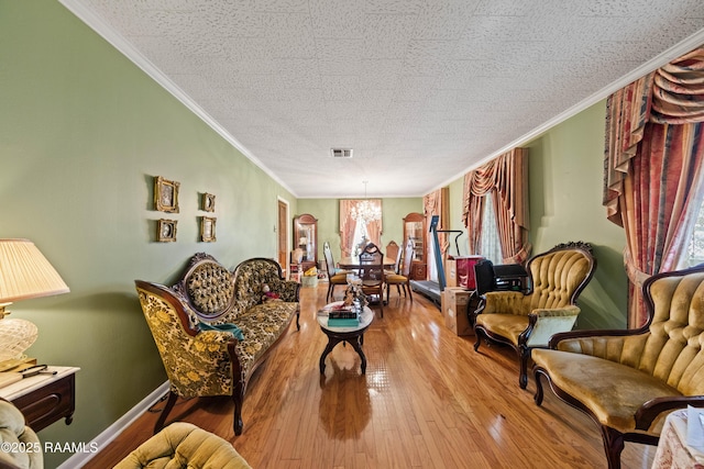 510 Monarch Dr, Lafayette, LA 70506 - sitting room with a chandelier, ornamental molding, wood finished floors, and baseboards