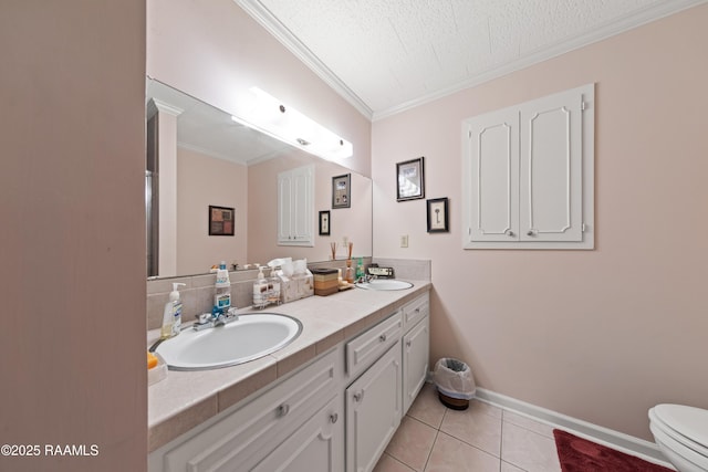 510 Monarch Dr, Lafayette, LA 70506 - full bathroom with crown molding, double vanity, toilet, tile patterned floors, and baseboards