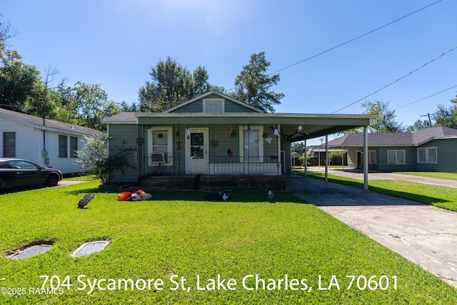 702 Sycamore St, Lake Charles, LA 70601 - view of front of property with covered porch, driveway, a front yard, and an attached carport