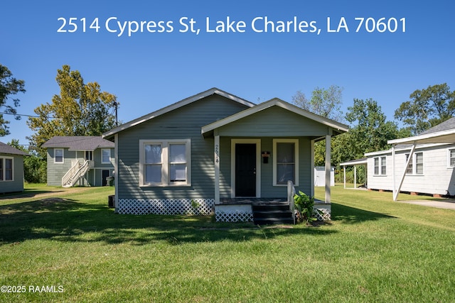 702 Sycamore St, Lake Charles, LA 70601 - view of front facade featuring a front yard and covered porch