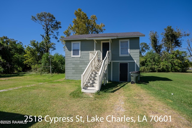 702 Sycamore St, Lake Charles, LA 70601 - raised beach house featuring a front yard and stairs